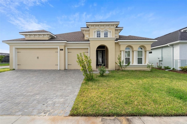 view of front of home featuring a front yard and a garage