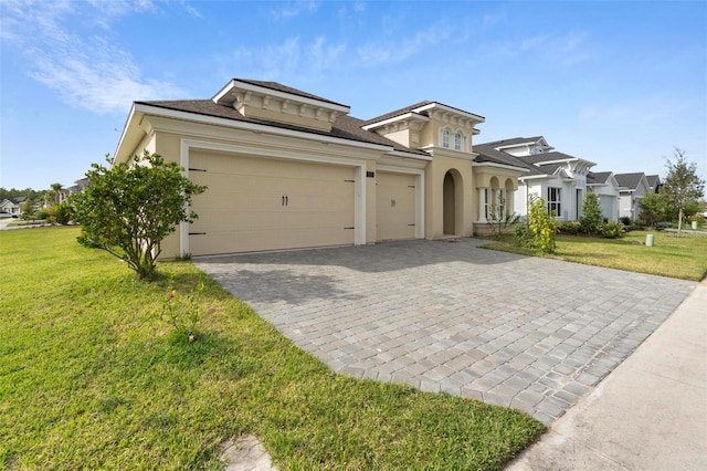 view of front of house featuring a garage and a front lawn