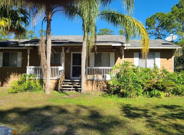 ranch-style home with a front lawn and covered porch