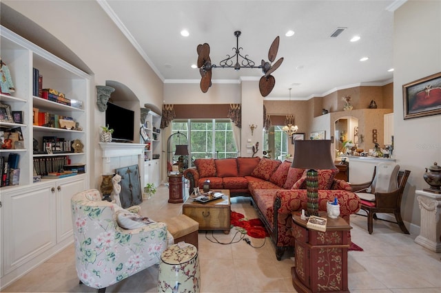 living room with a fireplace, light tile patterned floors, an inviting chandelier, and ornamental molding