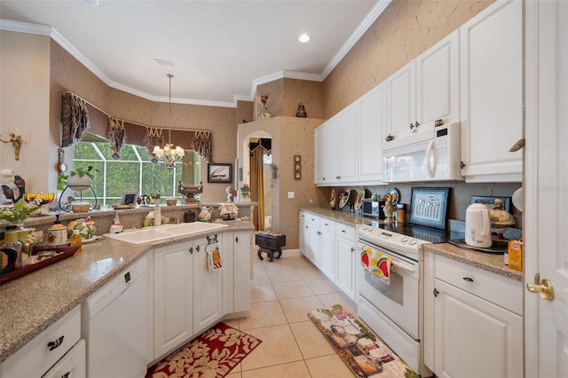 kitchen with white cabinetry, pendant lighting, and white appliances