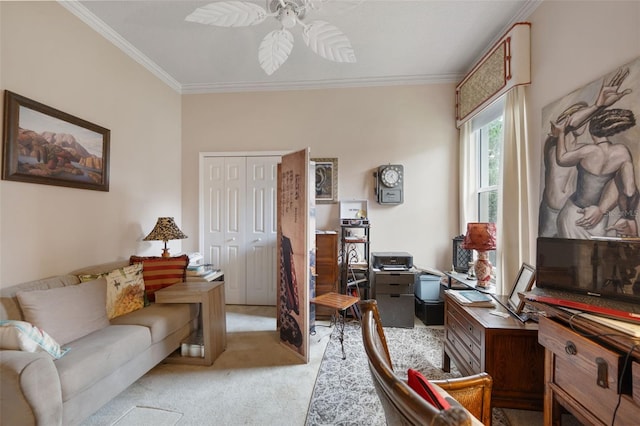 sitting room with ceiling fan, light colored carpet, and crown molding