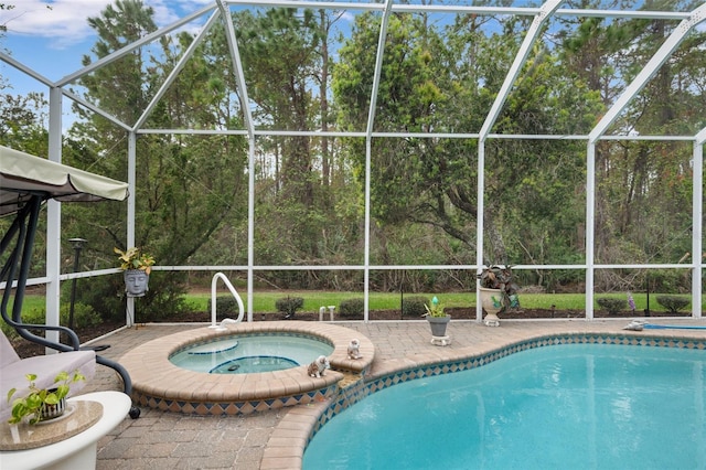 view of swimming pool with a lanai, an in ground hot tub, and a patio