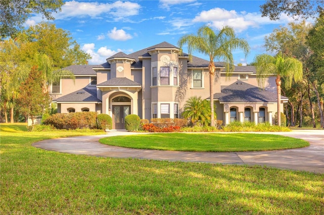 mediterranean / spanish-style house with a front yard