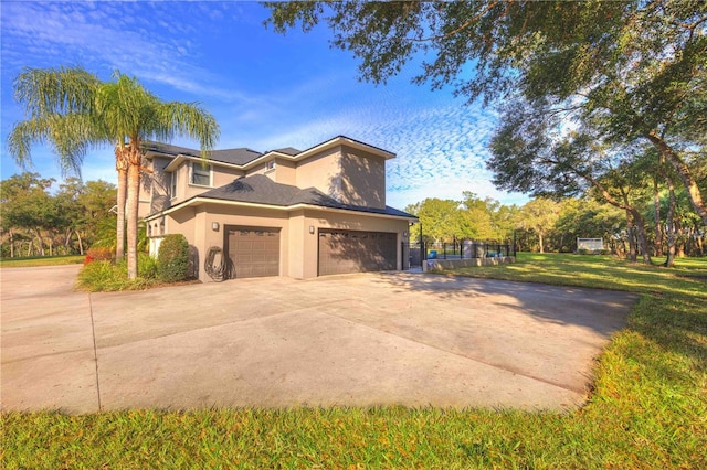 view of front of property with a front yard and a garage