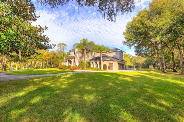 mediterranean / spanish house featuring a front lawn