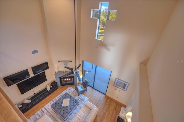 living room with a high ceiling and light hardwood / wood-style flooring