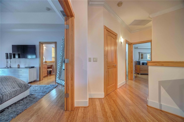 hallway with crown molding and light hardwood / wood-style flooring