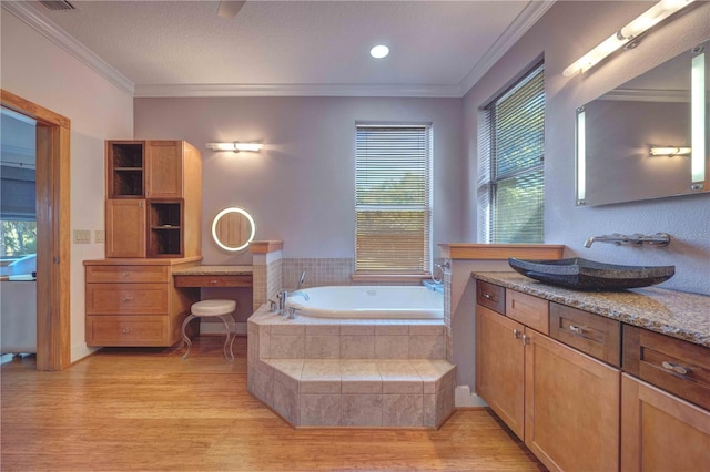 bathroom featuring hardwood / wood-style floors, crown molding, and a healthy amount of sunlight