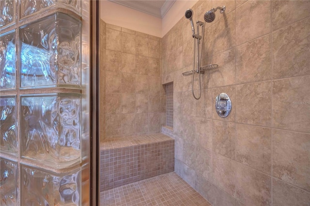 bathroom featuring a tile shower and ornamental molding