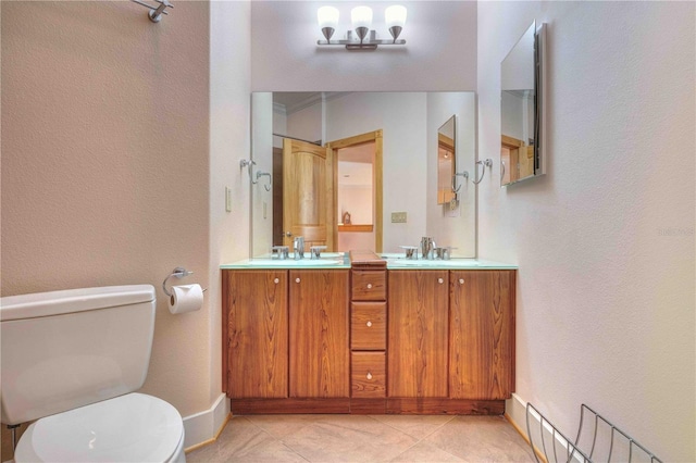 bathroom featuring tile patterned flooring, vanity, and toilet