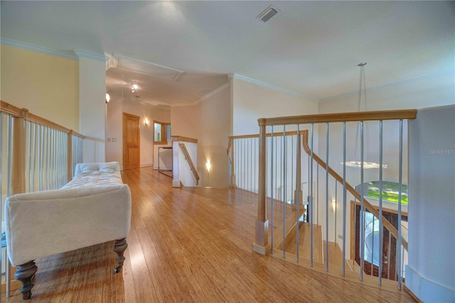 hall featuring crown molding and light hardwood / wood-style flooring