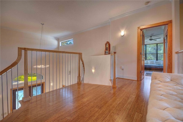 unfurnished room featuring ceiling fan, ornamental molding, and hardwood / wood-style flooring