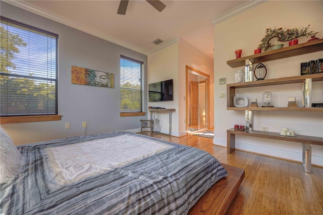 bedroom with ceiling fan, light hardwood / wood-style floors, and ornamental molding