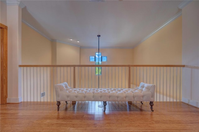 game room featuring light wood-type flooring and crown molding