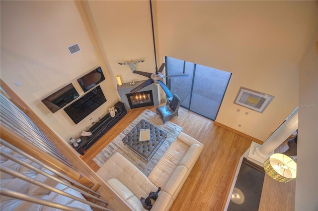 living room featuring a high ceiling and wood-type flooring