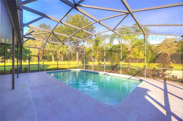 view of swimming pool with a lanai, a yard, and a patio