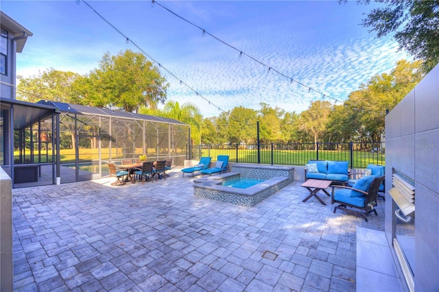 view of patio / terrace featuring an in ground hot tub, an outdoor hangout area, and a lanai