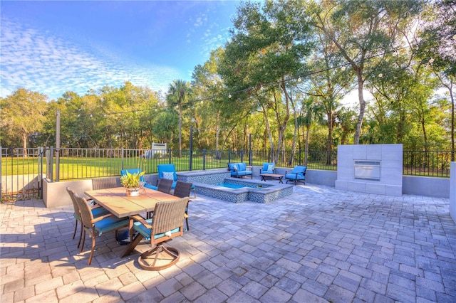 view of patio / terrace with an outdoor hangout area and a hot tub