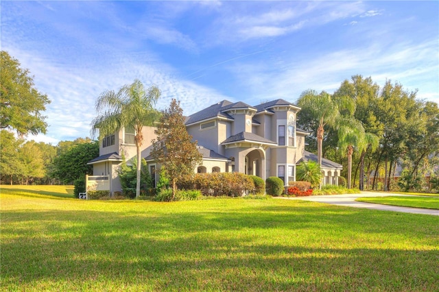 mediterranean / spanish home with a front yard