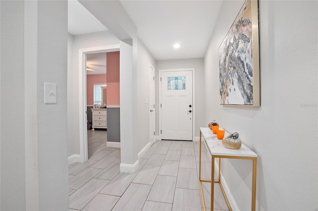 foyer entrance with light hardwood / wood-style flooring and a wealth of natural light