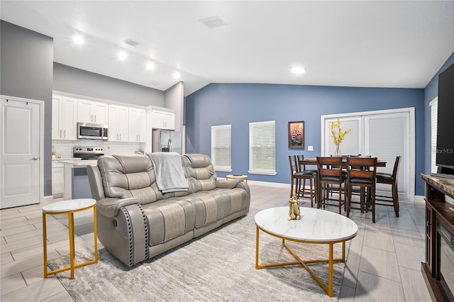 living room featuring lofted ceiling