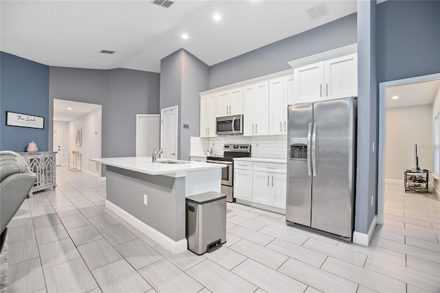 kitchen with white cabinetry, sink, a center island with sink, and appliances with stainless steel finishes