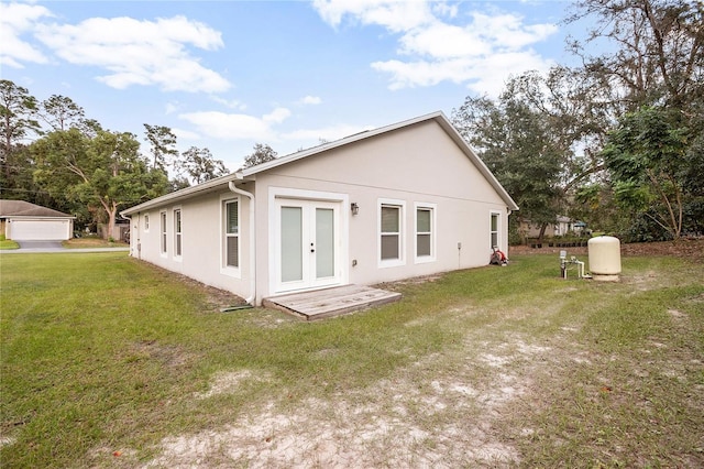 rear view of property featuring a lawn