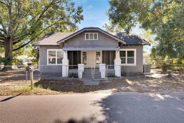 907 E N Bay St, Tampa, FL 33603 - bungalow-style house with a shingled roof, a fenced front yard, central air condition unit, and a gate