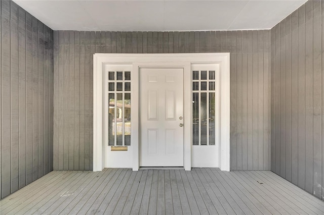 view of exterior entry with a wooden deck