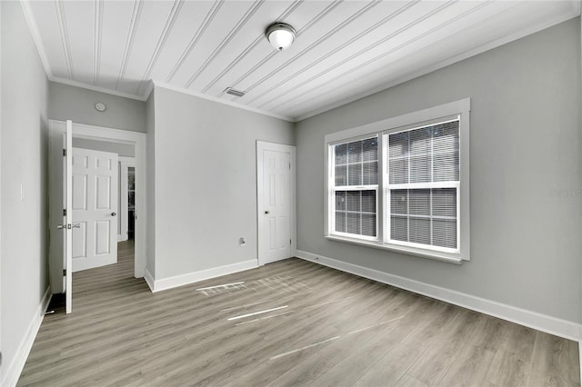 spare room with light hardwood / wood-style flooring and ornamental molding