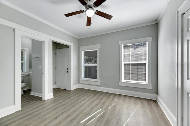 unfurnished bedroom with light hardwood / wood-style floors, ceiling fan, and crown molding