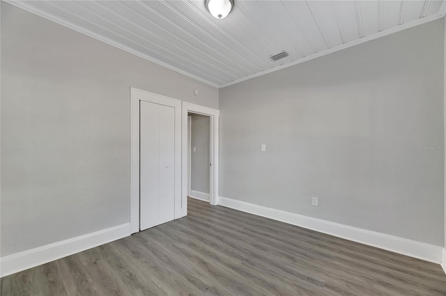 spare room with dark hardwood / wood-style floors and ornamental molding