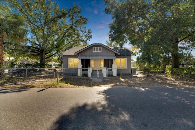907 E N Bay St, Tampa, FL 33603 - bungalow-style house with a fenced front yard, central air condition unit, a porch, and a gate