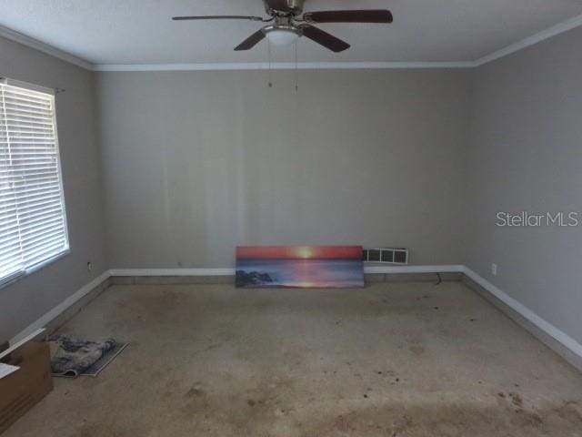 spare room featuring ceiling fan and ornamental molding