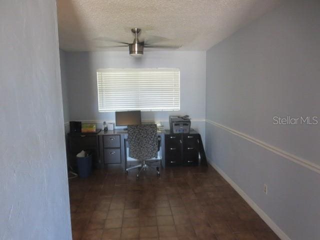 unfurnished office with a textured ceiling