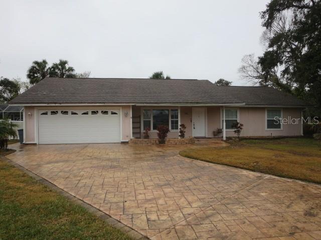 ranch-style home with a front yard and a garage