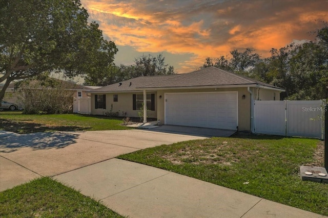 ranch-style house with a lawn and a garage