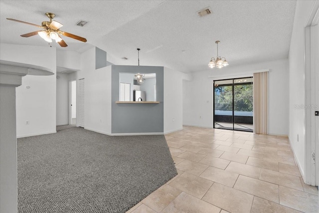 unfurnished room featuring ceiling fan with notable chandelier, light colored carpet, lofted ceiling, and a textured ceiling