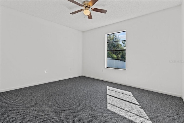 unfurnished room featuring dark colored carpet, ceiling fan, and a textured ceiling