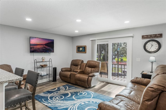 living room with hardwood / wood-style floors and a textured ceiling