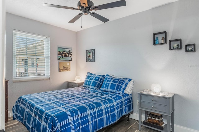 bedroom featuring ceiling fan and dark wood-type flooring