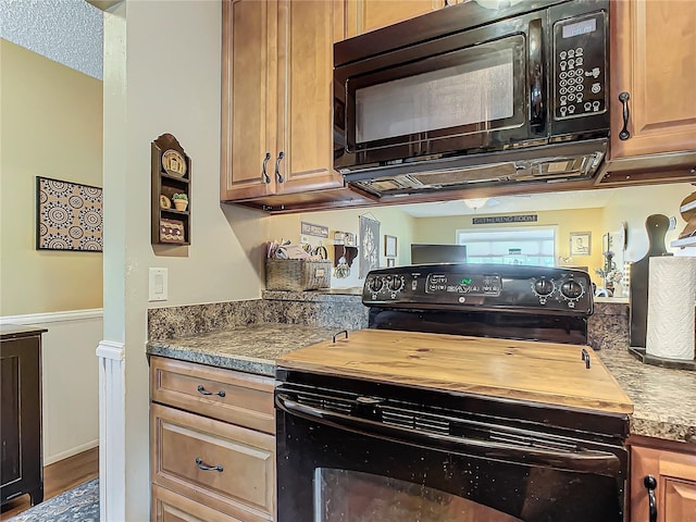 kitchen featuring hardwood / wood-style flooring and black appliances