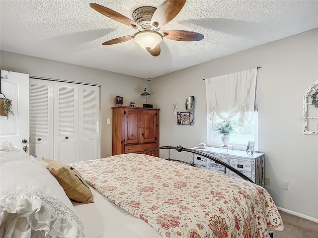 bedroom with a textured ceiling, a closet, ceiling fan, and carpet floors