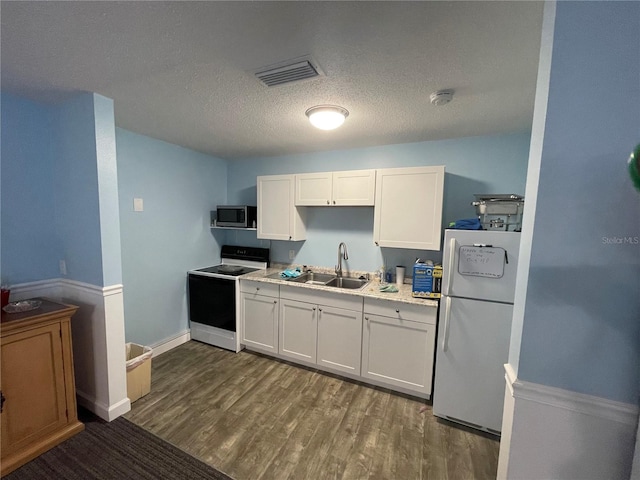 kitchen with white appliances, sink, a textured ceiling, dark hardwood / wood-style flooring, and white cabinetry