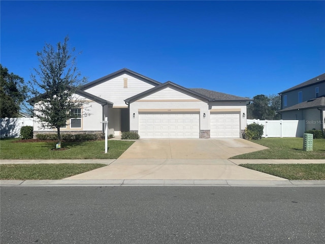 ranch-style house featuring a front lawn and a garage