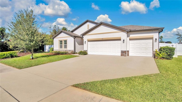 view of front of property featuring a front yard and a garage