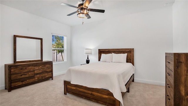 bedroom featuring ceiling fan and light carpet