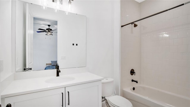 full bathroom featuring toilet, vanity, tiled shower / bath combo, and ceiling fan