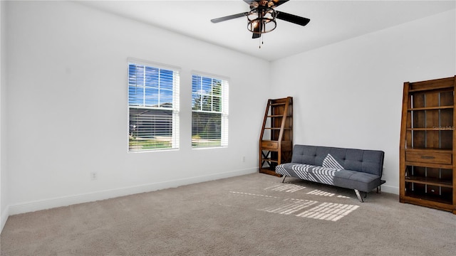 unfurnished room featuring light carpet and ceiling fan